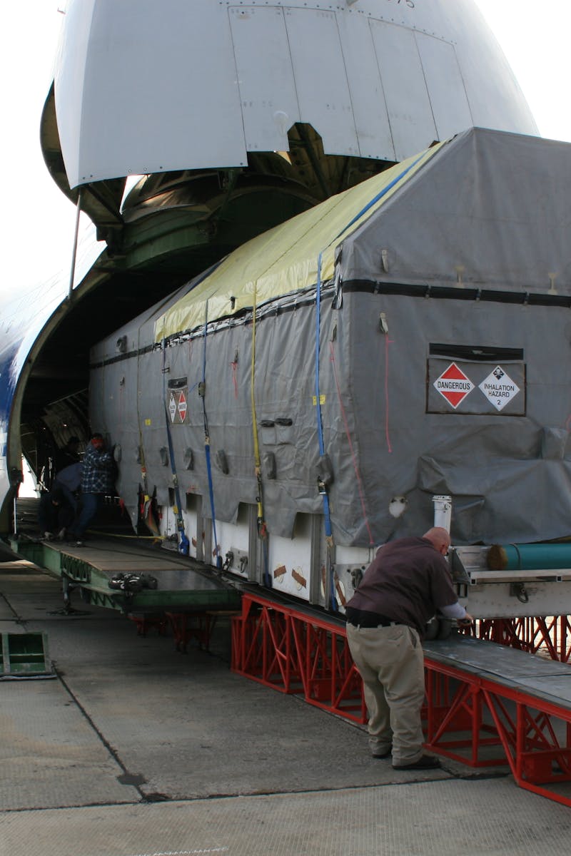 A massive cargo is loaded onto an Antonov aircraft at Baikonur, Kazakhstan.